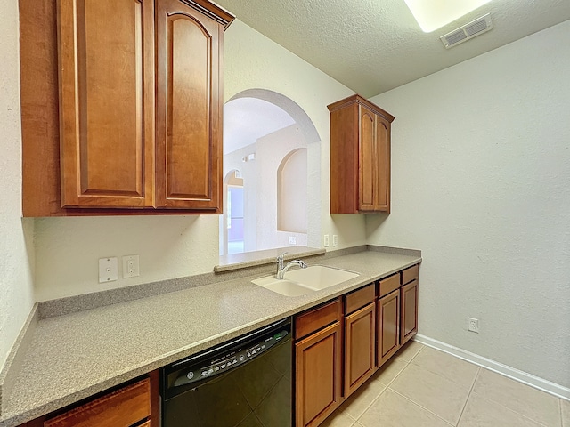 kitchen with black dishwasher, a textured ceiling, sink, and light tile patterned floors