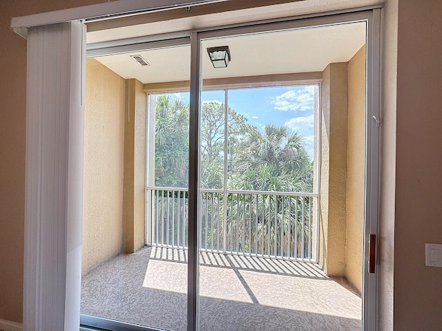 doorway to outside with carpet