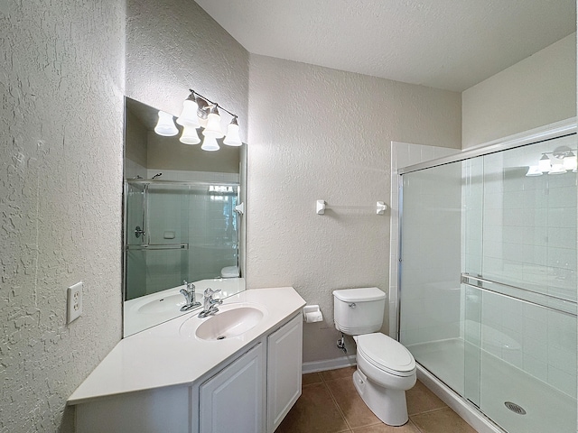 bathroom with a shower with door, vanity, a textured ceiling, and toilet