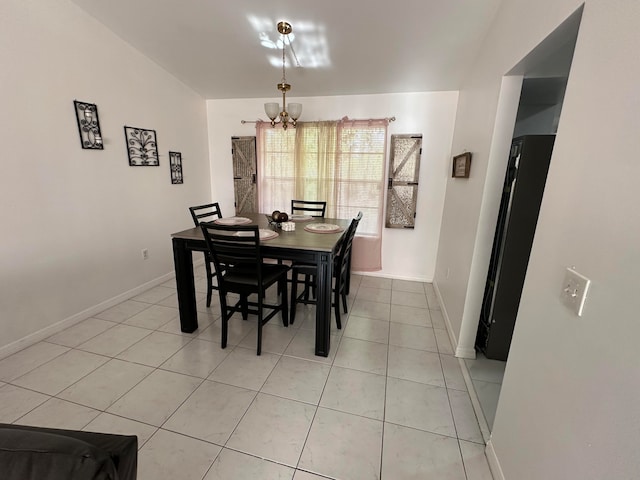 dining space with tile flooring and a chandelier