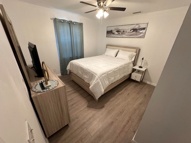 bedroom featuring wood-type flooring and ceiling fan