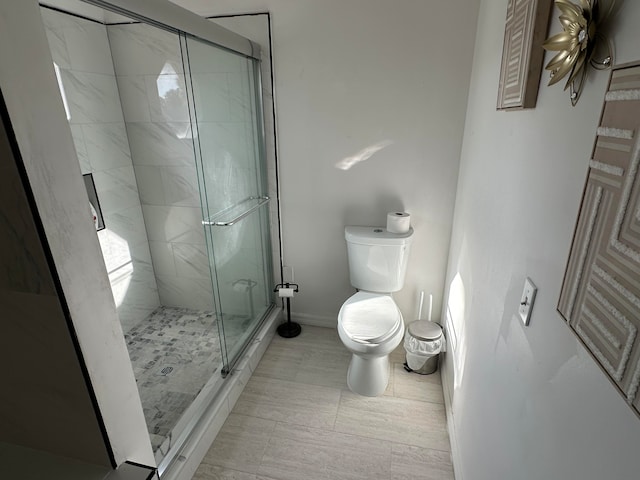 bathroom featuring an enclosed shower, toilet, and tile flooring