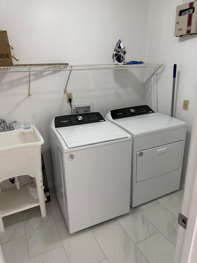 laundry area featuring hookup for a washing machine, separate washer and dryer, and light tile floors