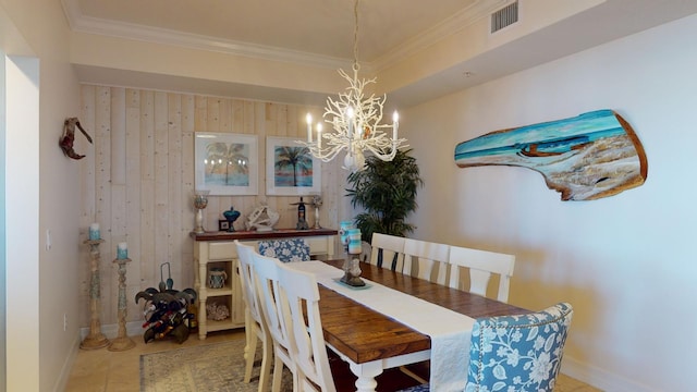 dining room with a notable chandelier, light tile flooring, and crown molding