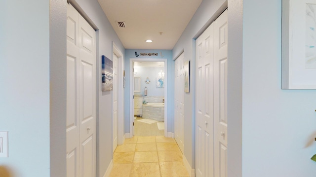 hallway featuring light tile floors