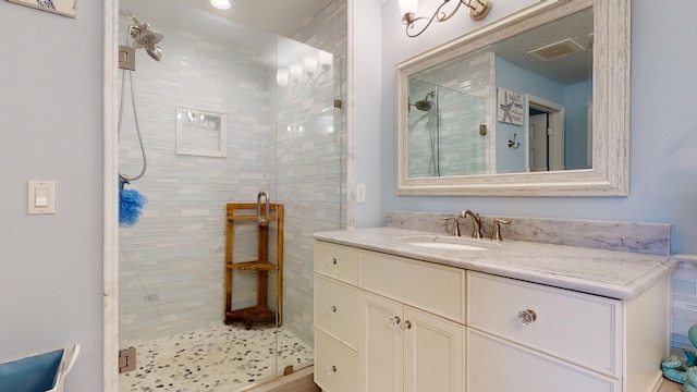 bathroom with oversized vanity and a shower with door