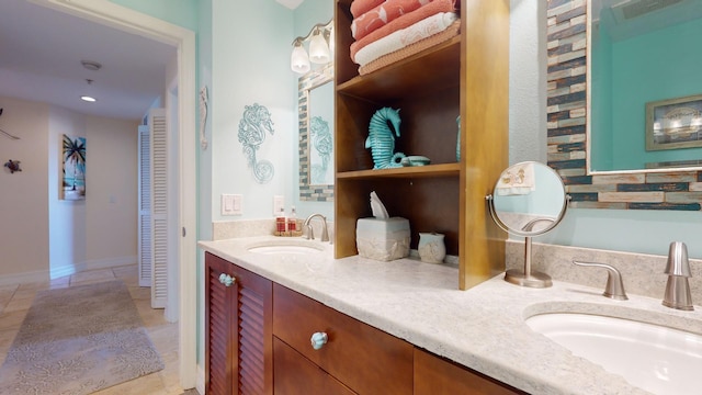 bathroom featuring double vanity, backsplash, and tile floors