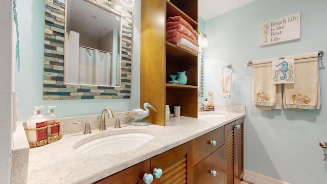 bathroom featuring oversized vanity and dual sinks