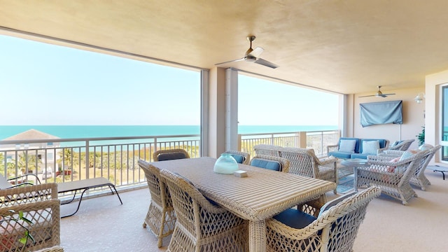 view of patio / terrace with a balcony, an outdoor hangout area, ceiling fan, and a water view