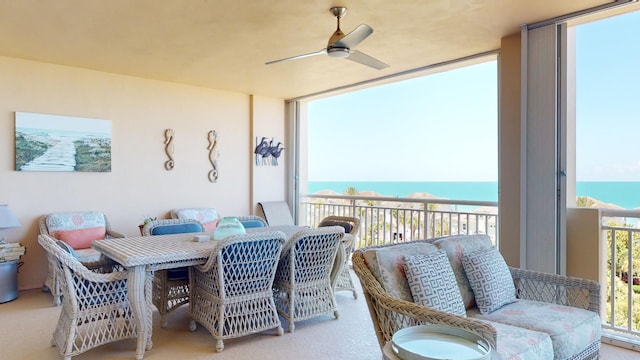 interior space with a water view and ceiling fan