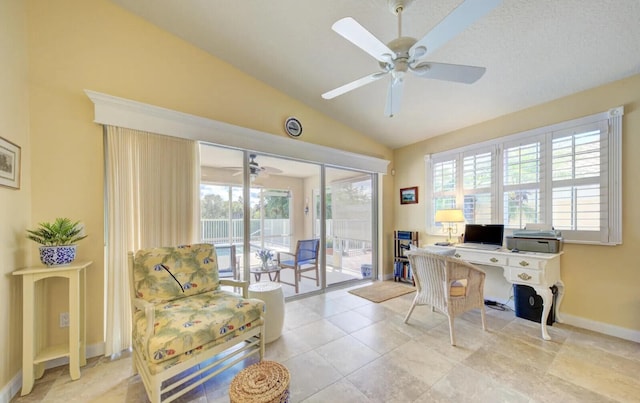 tiled office space featuring vaulted ceiling and ceiling fan