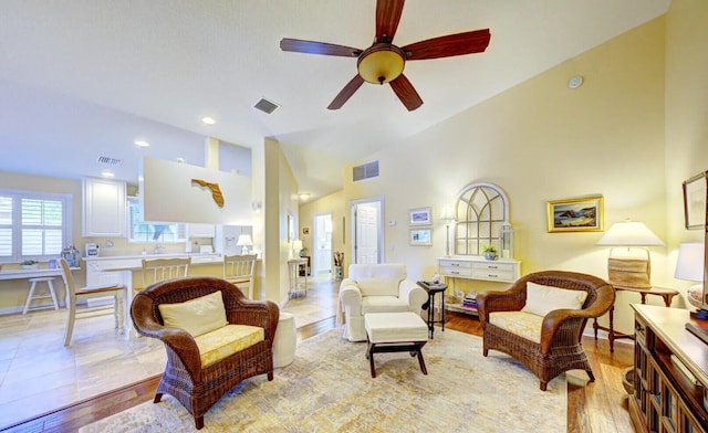 tiled living room with ceiling fan