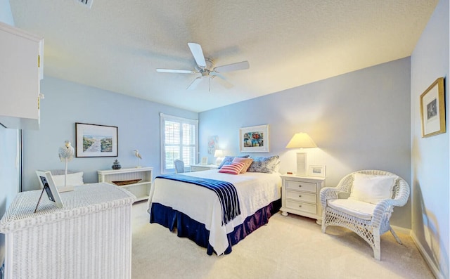 carpeted bedroom with a textured ceiling and ceiling fan