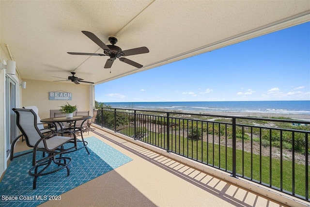 balcony with a water view and ceiling fan