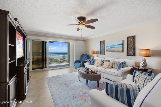 tiled living room featuring ceiling fan, crown molding, and a textured ceiling