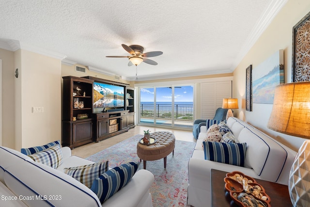 living room featuring crown molding, ceiling fan, a textured ceiling, and light tile flooring