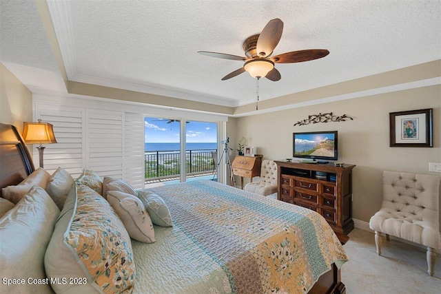 tiled bedroom featuring a textured ceiling, ceiling fan, access to exterior, and a water view