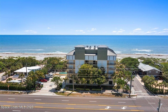 drone / aerial view with a water view and a view of the beach