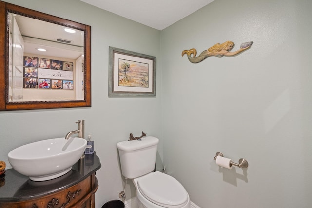 bathroom with toilet and vanity