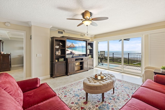 living room featuring a water view, ceiling fan, crown molding, light tile flooring, and a textured ceiling