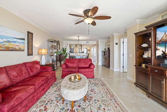 living room with ornamental molding, ceiling fan, light tile floors, and a textured ceiling