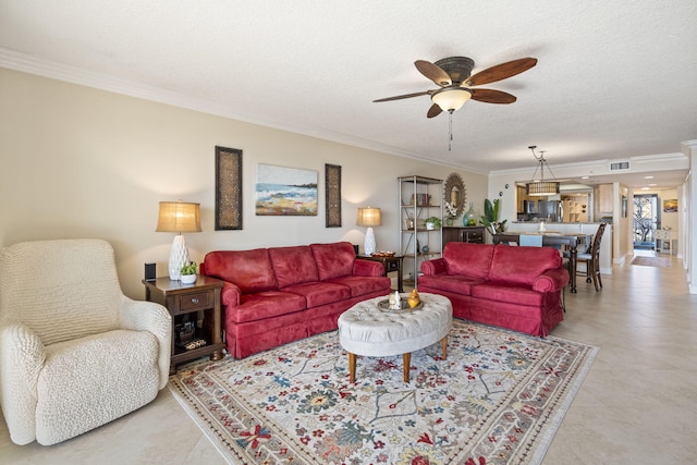 tiled living room featuring crown molding, ceiling fan, and a textured ceiling