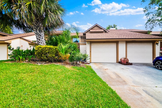 view of front of house with a front lawn and a garage