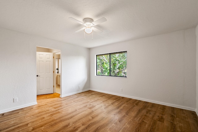 spare room featuring ceiling fan and light hardwood / wood-style floors