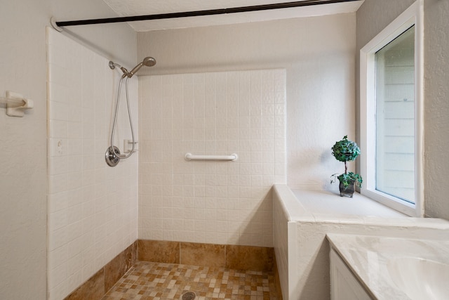 bathroom with vanity and a tile shower