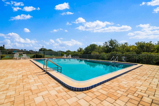 view of swimming pool with a patio area