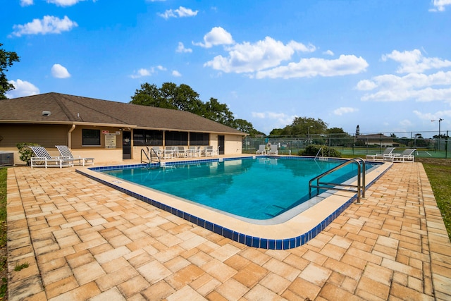 view of swimming pool with a patio area