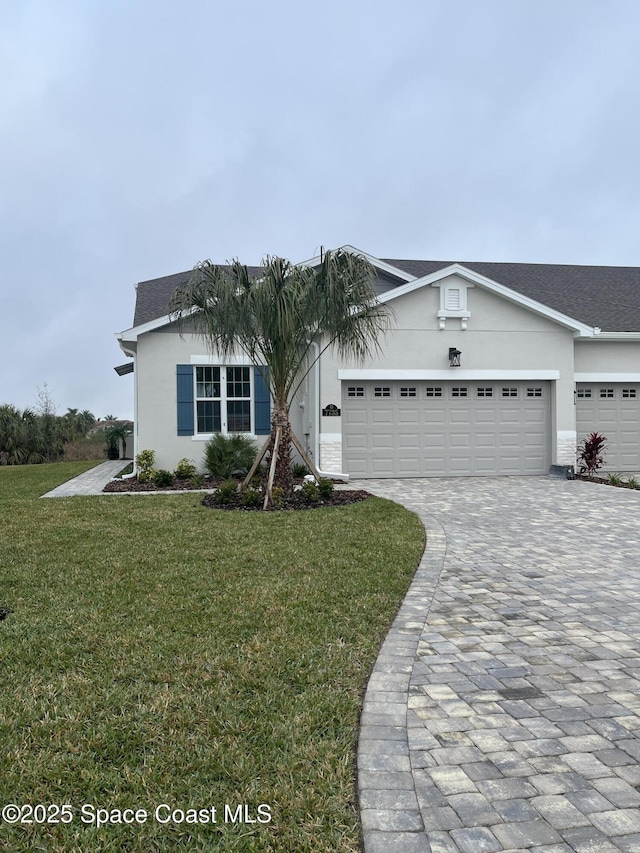 ranch-style house featuring a garage and a front yard