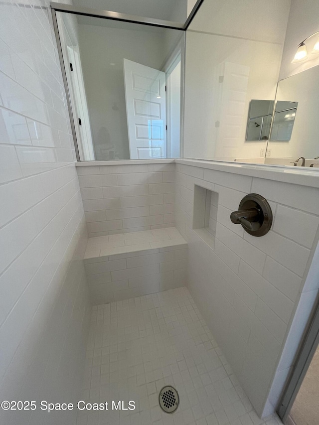 bathroom with a tile shower