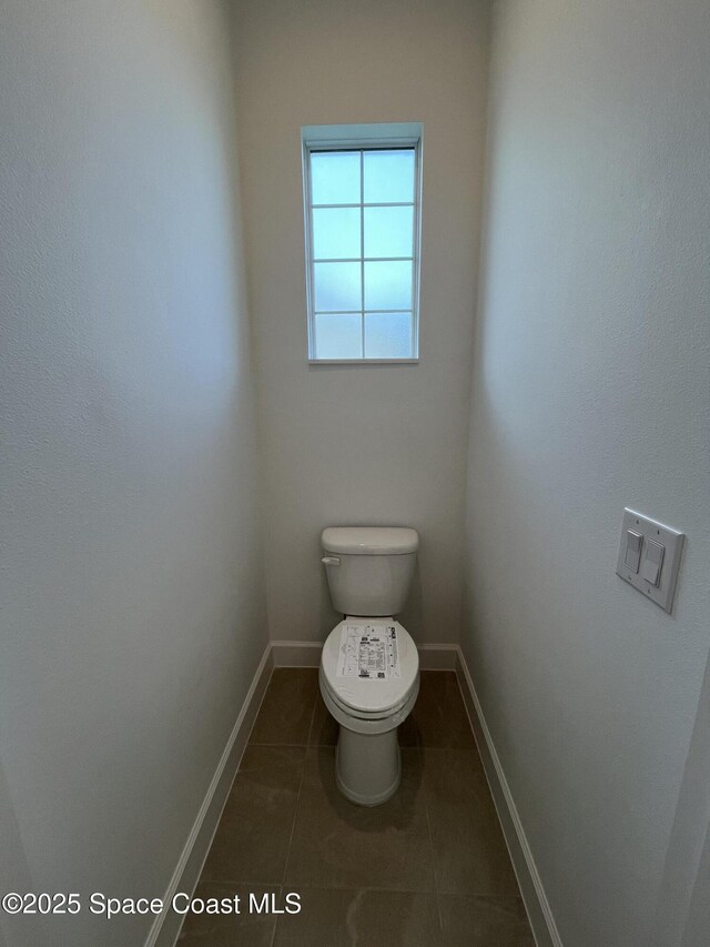 bathroom featuring tile patterned flooring and toilet