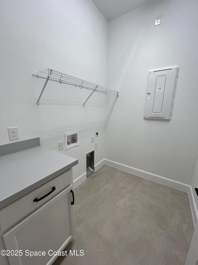 laundry area with electric dryer hookup, hookup for a washing machine, and cabinets