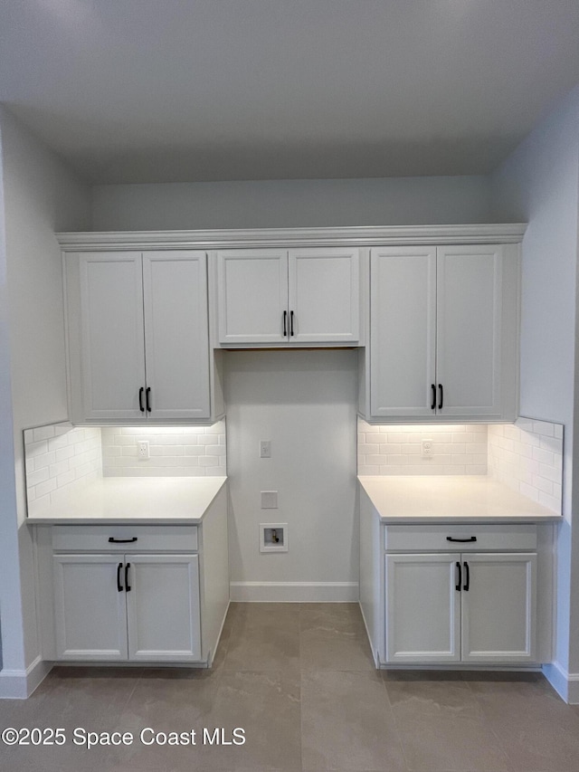 laundry area featuring cabinets, hookup for a washing machine, and light tile patterned floors