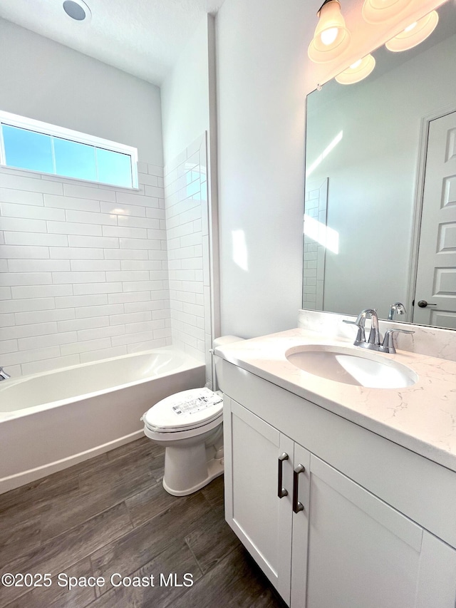 full bathroom featuring vanity, shower / bathing tub combination, wood finished floors, and toilet