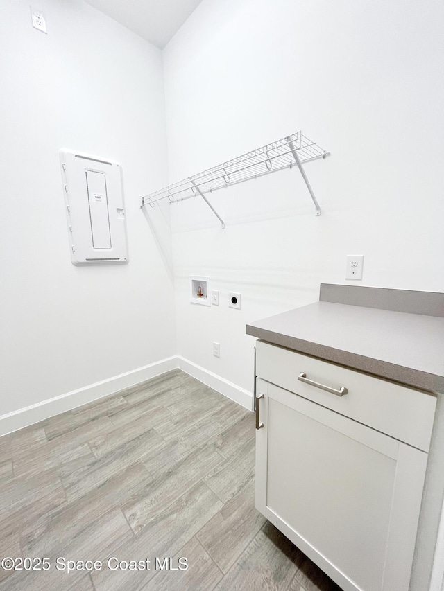 washroom featuring washer hookup, light wood finished floors, hookup for an electric dryer, laundry area, and baseboards