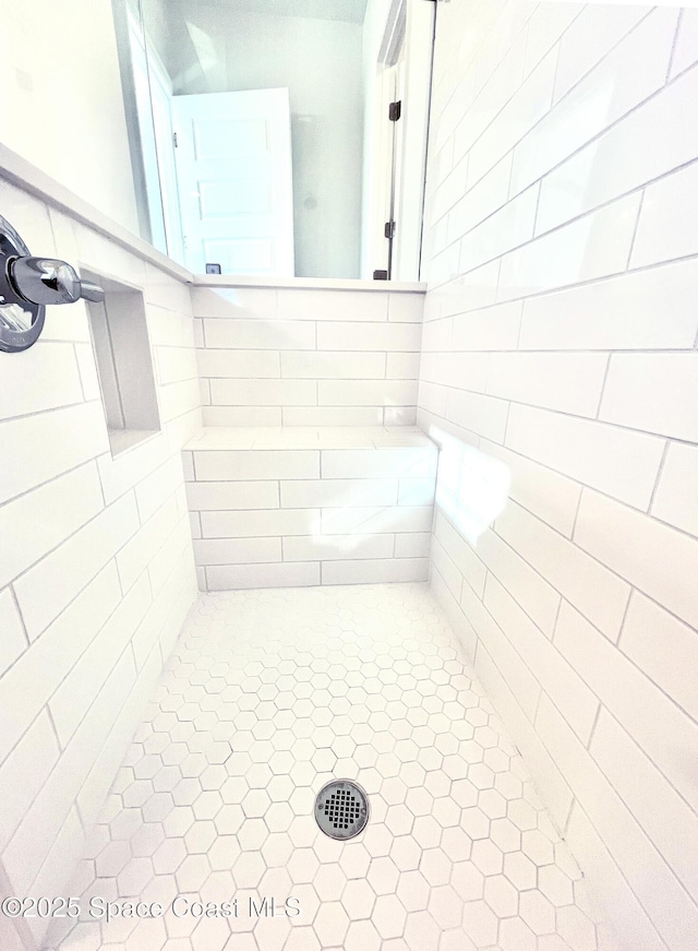 bathroom with a tile shower