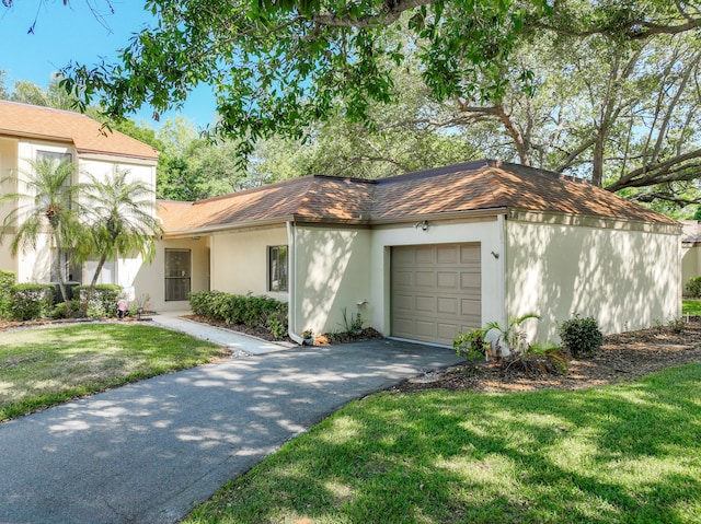 view of front of home with a front lawn and a garage