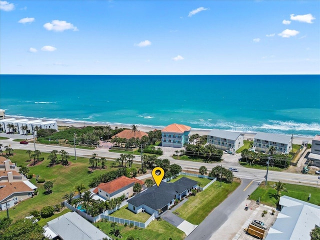 drone / aerial view featuring a water view and a view of the beach