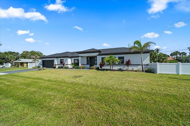 view of front of house featuring a garage and a front yard