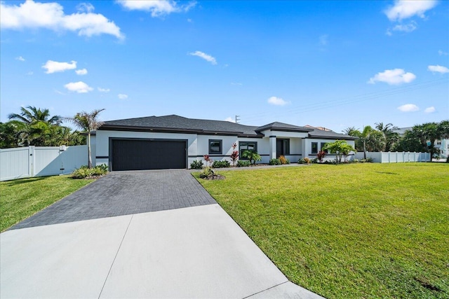 view of front of house featuring a front yard and a garage