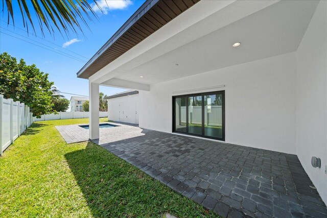 view of yard with a fenced in pool and a patio