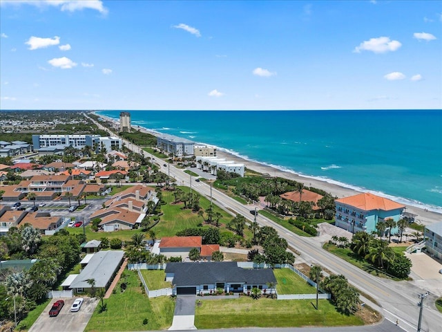 bird's eye view with a water view and a beach view