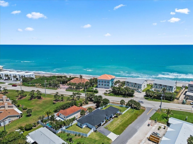 birds eye view of property featuring a water view and a beach view