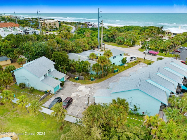 drone / aerial view featuring a water view and a beach view