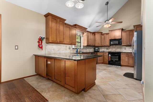 kitchen featuring backsplash, lofted ceiling, kitchen peninsula, and black appliances