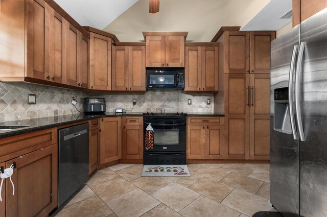 kitchen featuring backsplash, dark stone counters, vaulted ceiling, and black appliances