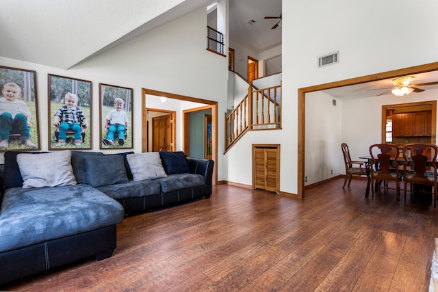 living room with dark wood-type flooring, high vaulted ceiling, and ceiling fan